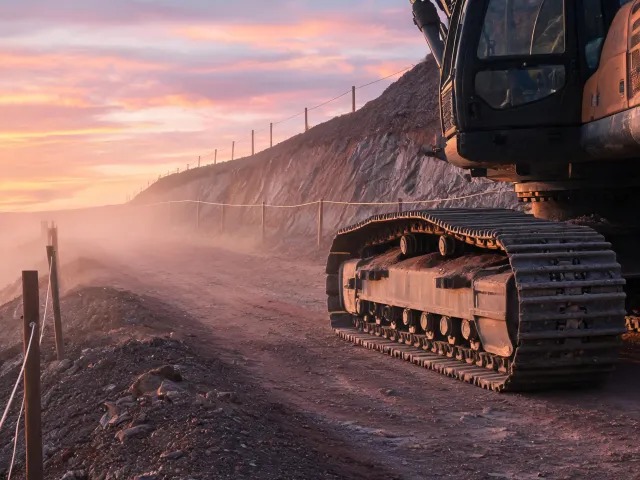 Highway cut excavator track on base course