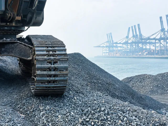 Coastal port stockyard excavator tracks